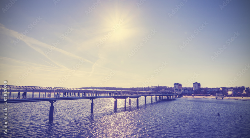 Vintage toned pier against sun, Heringsdorf, Germany.
