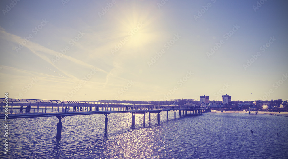 Fototapeta premium Vintage toned pier against sun, Heringsdorf, Germany.