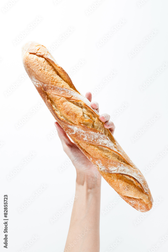 Hand holding a French baquette