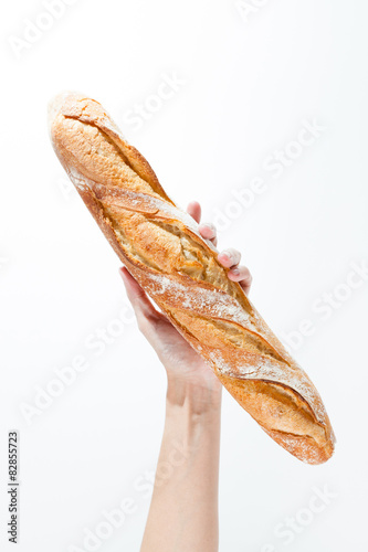 Obraz na płótnie Hand holding a French baquette w salonie