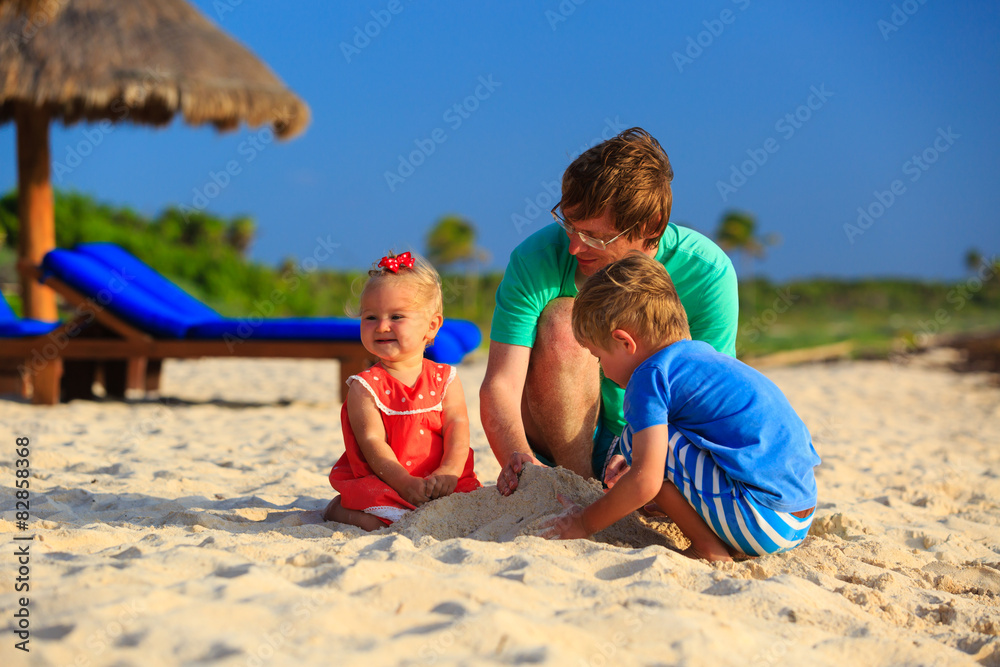 father and two kids playing with sand on the beach father and two kids playing with sand on the beach