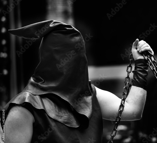 executioner with black hood on his head and the chain