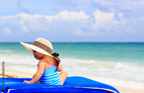 cute little girl in big hat on summer beach