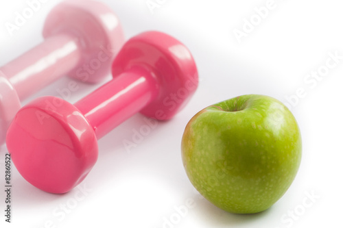 Food and exercise concept weights and apple