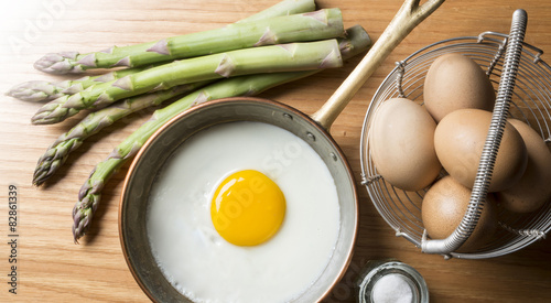 eggs with asparagus on the wooden table
