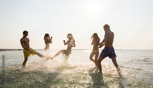happy friends having fun on summer beach