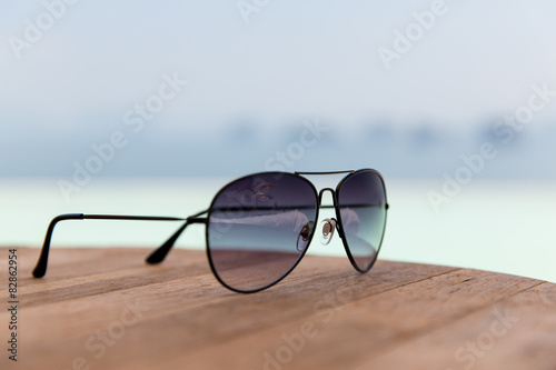 shades or sunglasses on table at beach