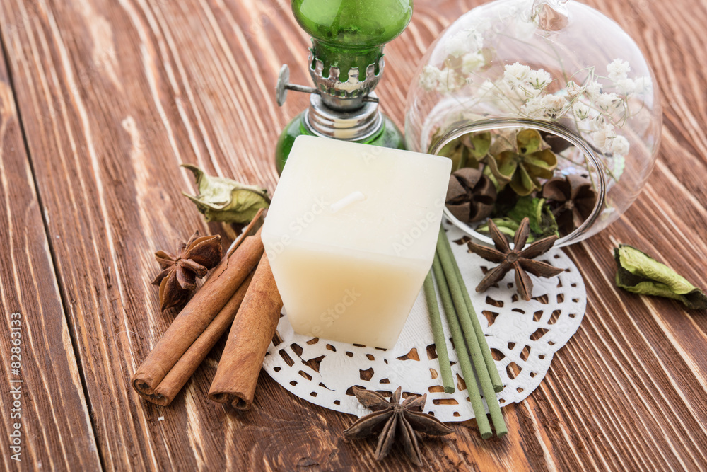 spa stuff on wooden background: candle, aroma