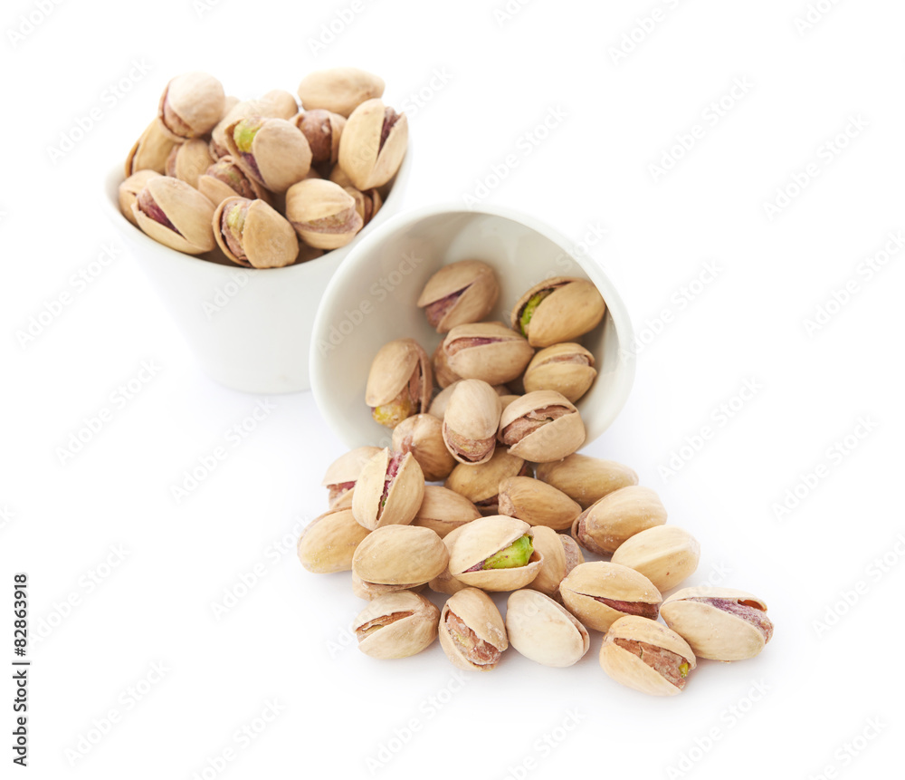 Heap of pistachios nuts isolated on the white Heap of pistachios nuts isolated on the white