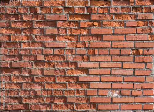 cracked worn red brick wall...