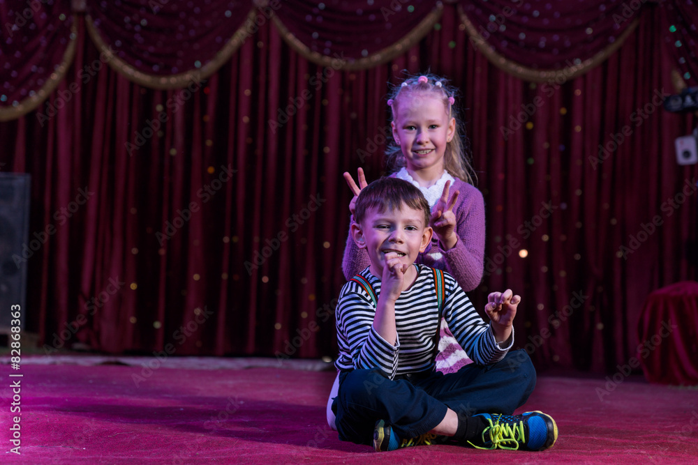 Boy and Girl Sitting Together on Stage