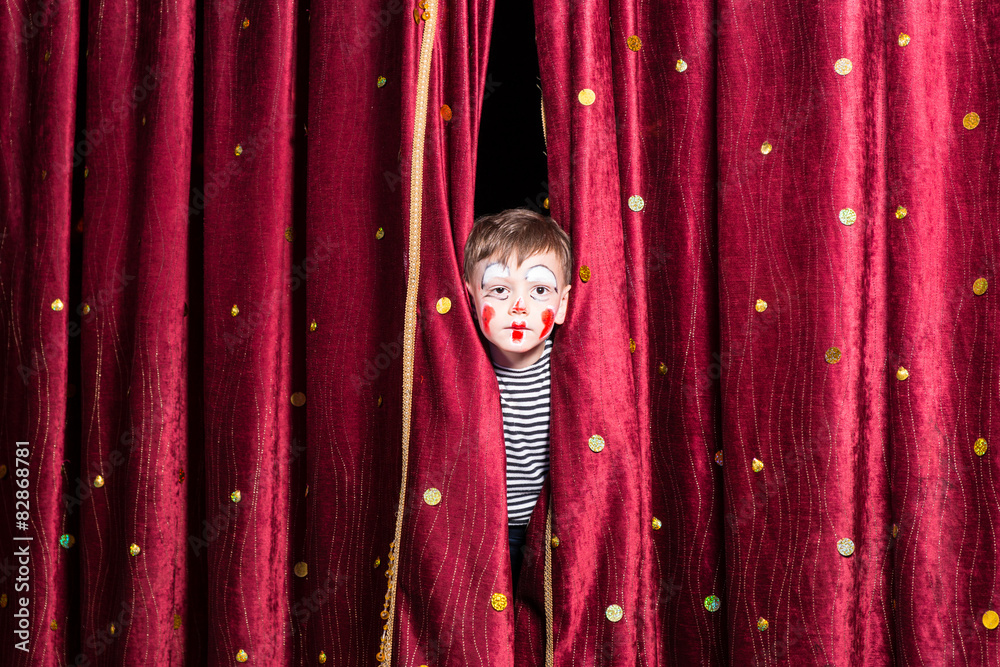 Cute little boy wearing face paint and a costume