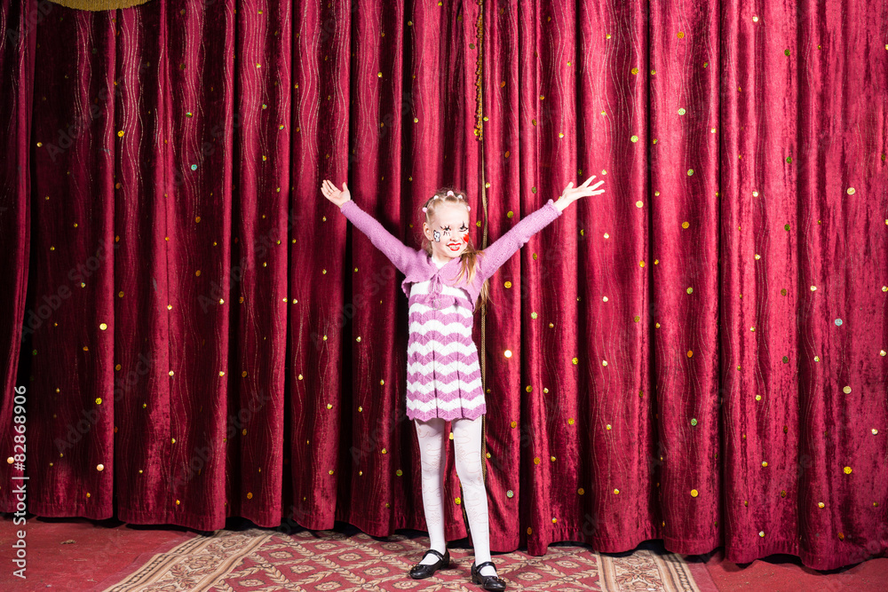 Little girl standing on stage during a performance