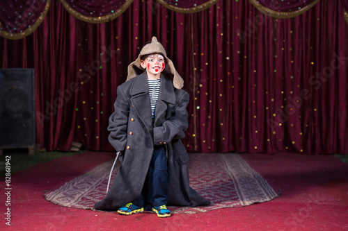 Obraz na płótnie Boy wearing retro coat and Russian hat on stage w salonie