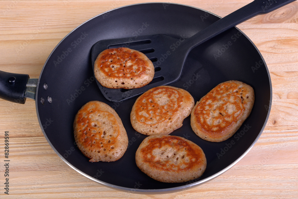 Frying pan with fritters Frying pan with fritters