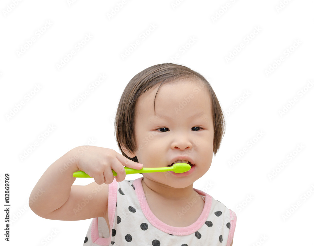 Little Asian girl cleansing her tooth by toothbrush over white b Little Asian girl cleansing her tooth by toothbrush over white b