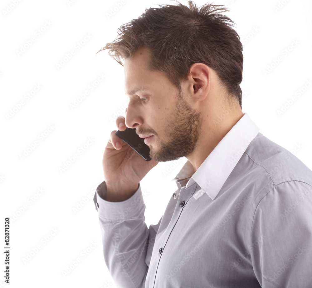 Young Businessman Talking over Cell Phone on Isolated White Back Young Businessman Talking over Cell Phone on Isolated White Back