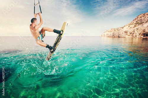 Wakeboarder making tricks on the sea. Wakeboarding. Water sports