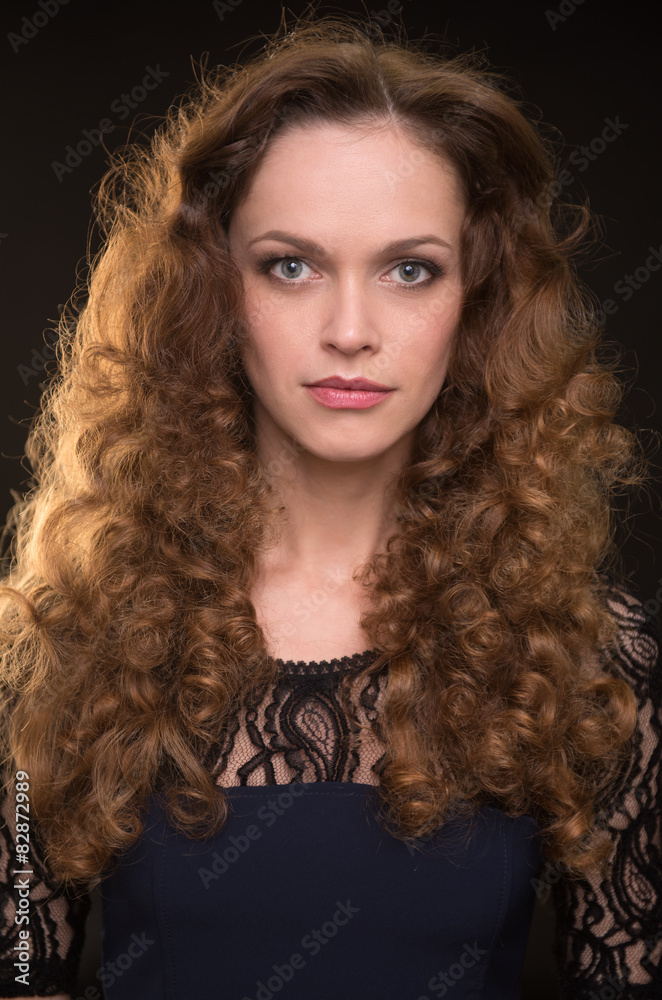 Beautiful woman with long brown curly hair Beautiful woman with long brown curly hair