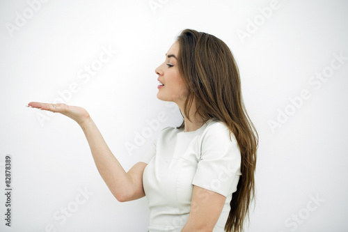 Woman showing a product - empty copy space on the open hand palm