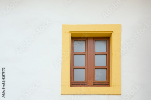 old colorful window in a white exterior wall