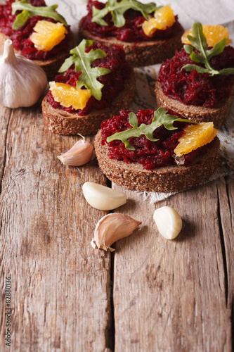 Sandwich with beets, oranges and rucola close-up. Vertical
