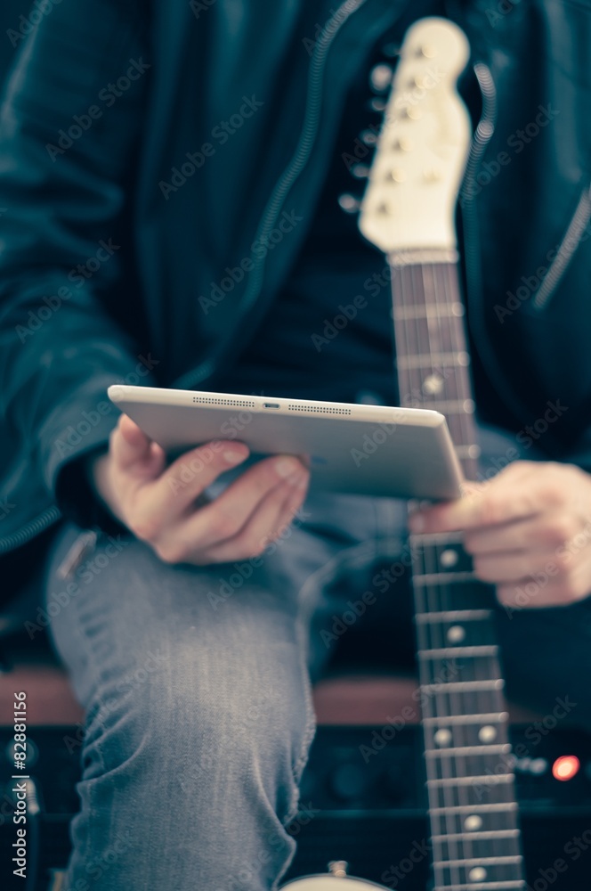 Man with tablet and electric guitar Man with tablet and electric guitar