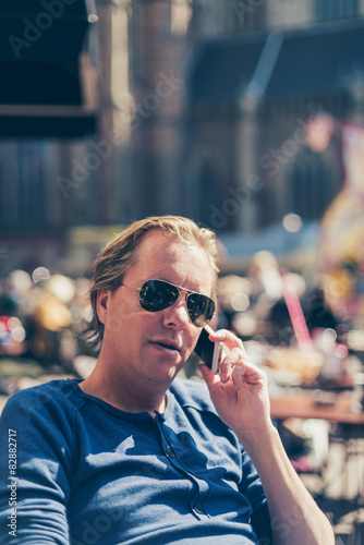 Attractive man sitting talking on his mobile