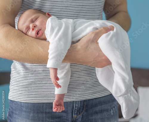 Vászonkép Monthly baby sleeping on the arm