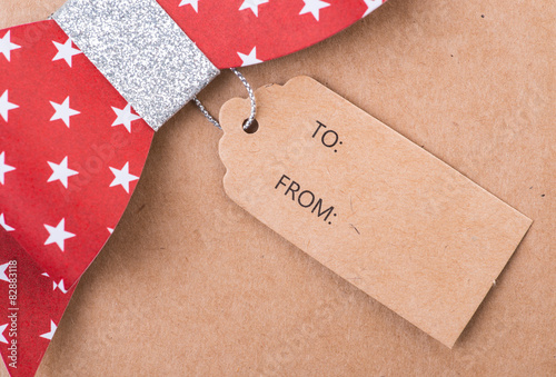 Fotografie Red gift bow with printed stars and tag
