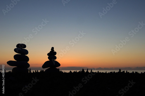 Sunset sky with stone silhouette couple