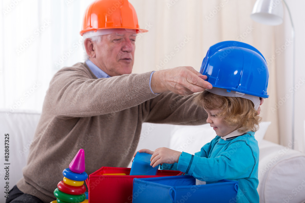 Grandfather and grandkid wearing helmets Stock-Foto | Adobe Stock