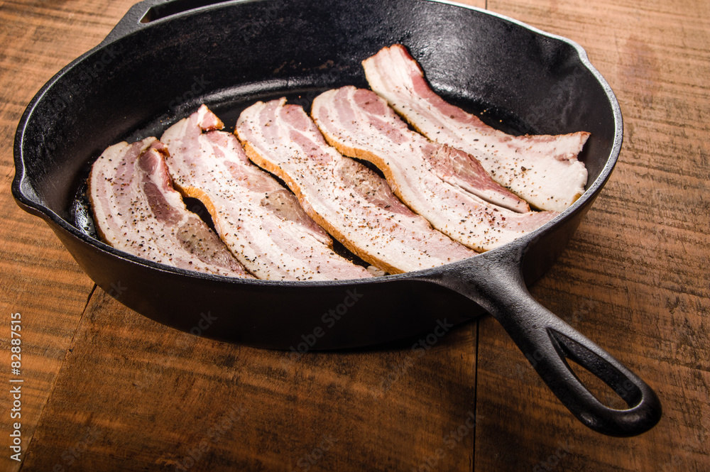Metal frying pan with strips of bacon Metal frying pan with strips of bacon