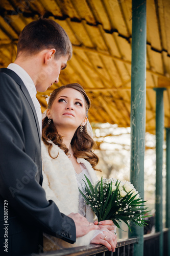 The bride and groom hugging on shore of Lake in a park. Wedding © andreiko