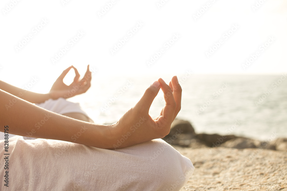 young woman meditation in a yoga pose on the tropical beach Stock Photo ...