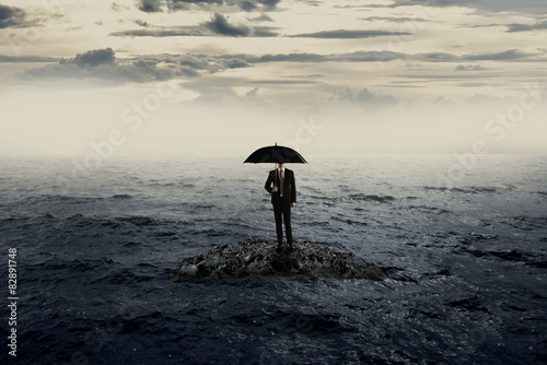 Man Holding Umbrella Stading On The Rock On The Sea