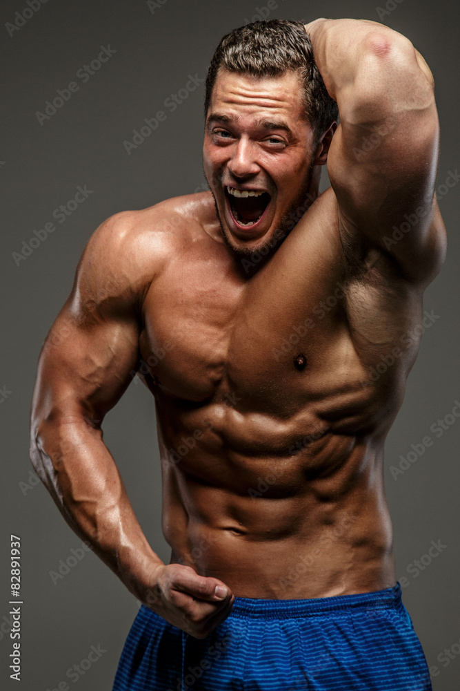 Fototapeta premium Emotional muscular guy in studio