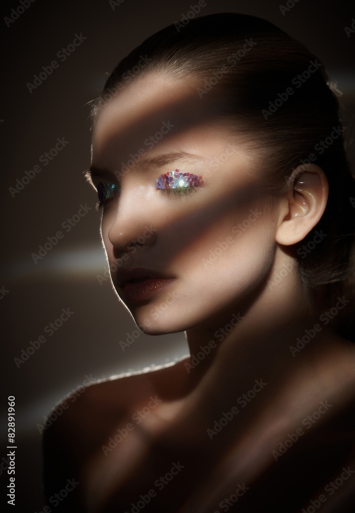 Fototapeta premium Portrait of a woman in artistic light