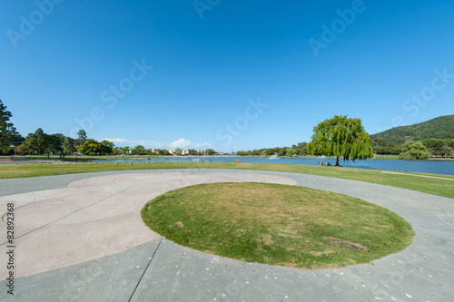 Park with lake, fountains tree and grass