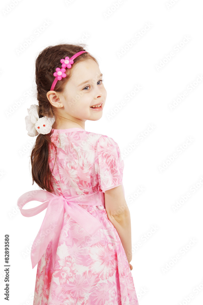 Pretty cute young girl wearing the pink dress looking back Pretty cute young girl wearing the pink dress looking back