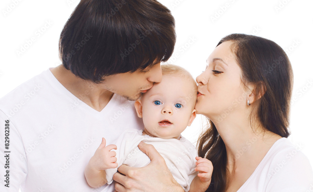 Happy family, portrait of mother and father kissing baby Happy family, portrait of mother and father kissing baby
