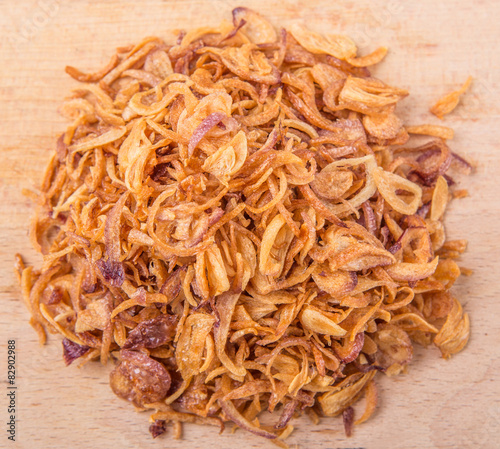 Deep fried shallots for garnishing on wooden surface