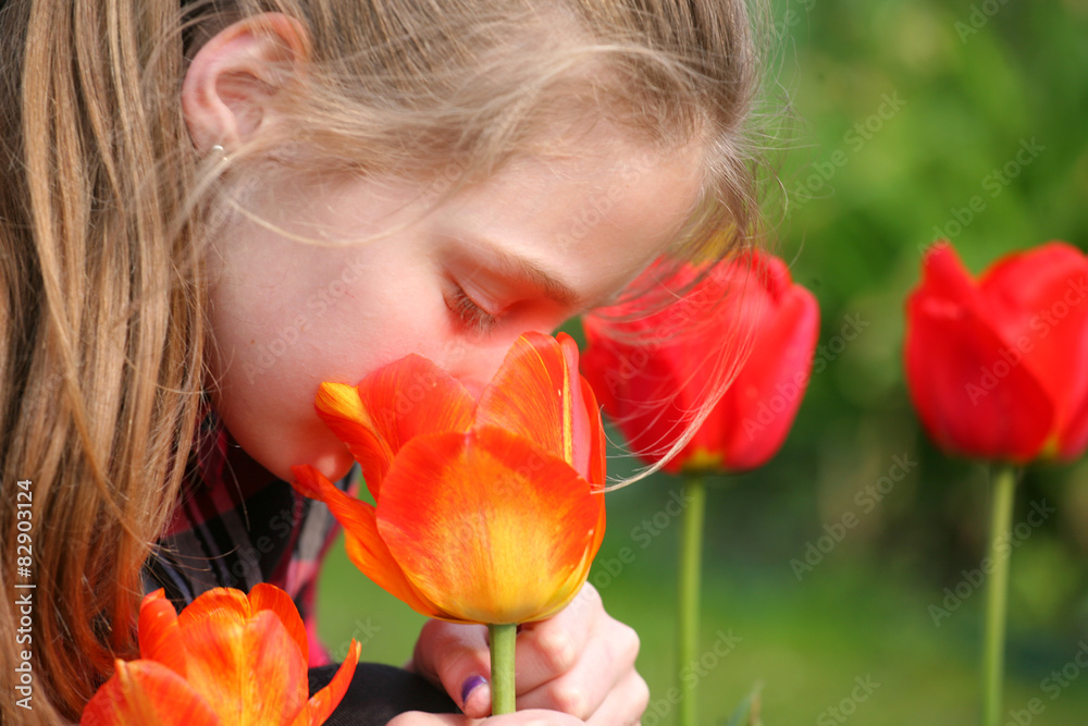 girl smelling flowers in the garden
girl smelling flowers in the garden