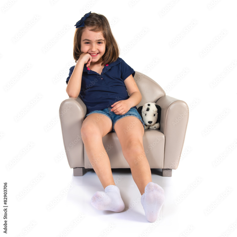 Girl sitting on small armchair Girl sitting on small armchair