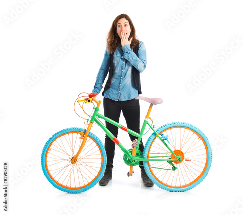 Surprised woman with colorful bicycle
