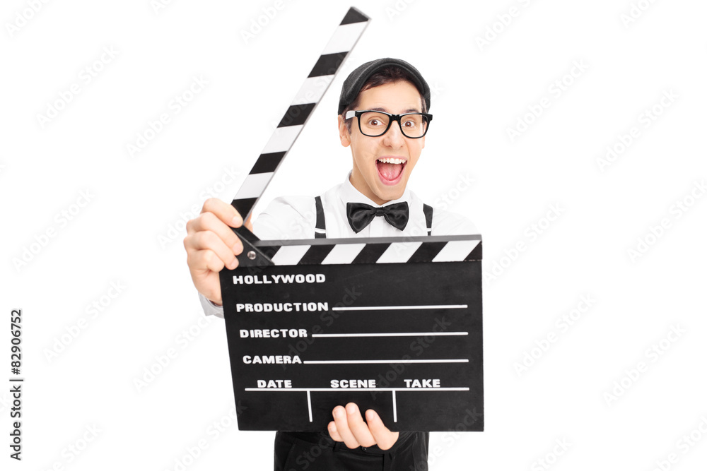 Retro guy posing behind a movie clapperboard Retro guy posing behind a movie clapperboard