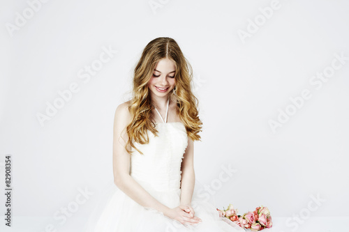Teenage flower girl in white