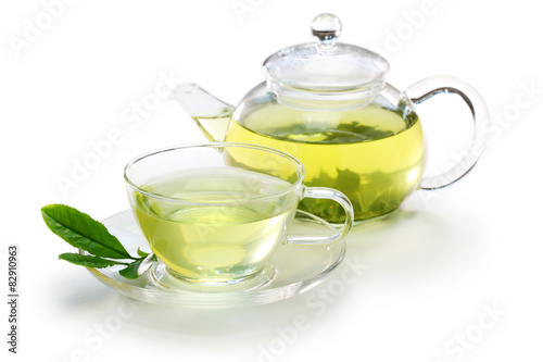 glass cup of Japanese green tea and teapot on white background