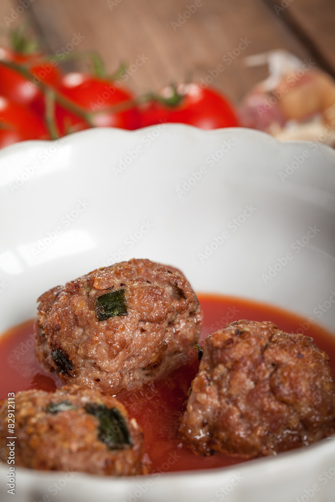 Roasted meatballs on wooden background