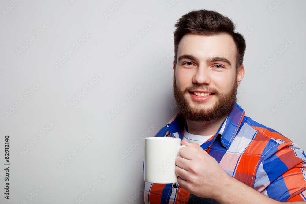 young bearded man with a cup of coffee young bearded man with a cup of coffee